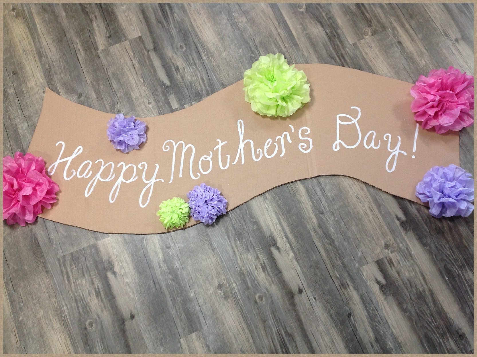 Mother's Day | Party | Cute Banner Idea | Mother's Day Decor | This easy to make banner adds a pretty festive look. Make it for Mother's Day or any other special holiday. It's cheap to make, too. Six Clever Sisters has an easy tutorial on making the banner as well as the tissue paper flowers.