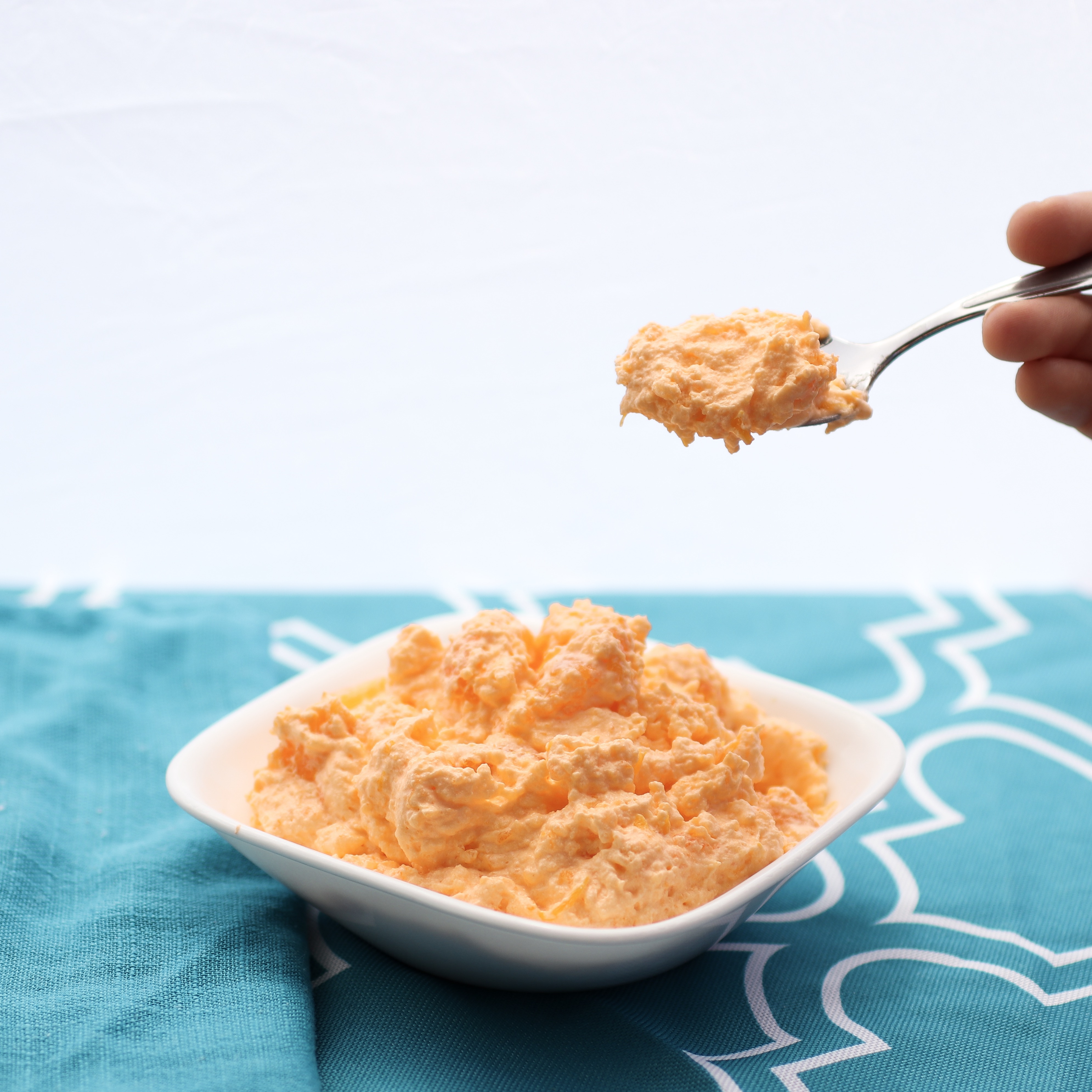 Creamy Orange Dreamsicle Dessert | Orange Creamsicle | Orange Dessert | Creamsicle Recipe | Orange Fluff | Orange Fluff Recipe | Fluffy Orange Dessert | No Bake Recipe | This Creamy Orange Dreamsicle Dessert is such a yummy and easy dessert! It's great for any summer get-together . . . and it doesn't require any baking! Find the recipe at SixCleverSisters.com