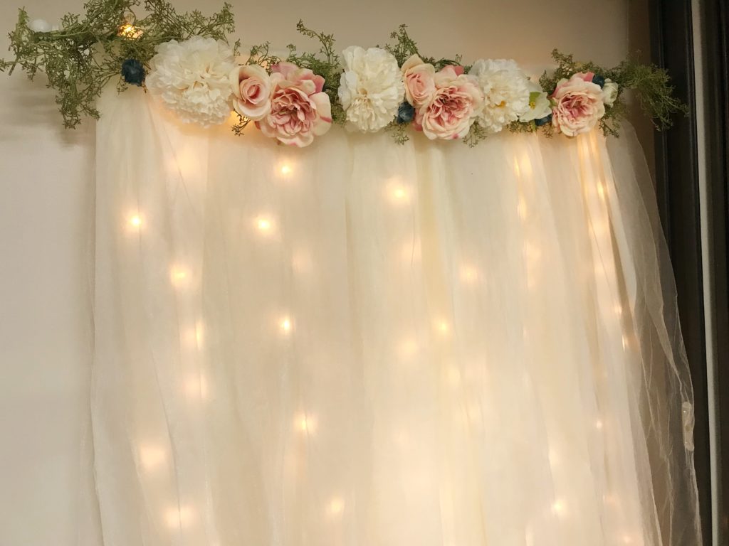 How to Make a Wedding Backdrop | DIY Lit Tulle Backdrop | Bridal | Wedding | Bridal Shower | Wedding Shower | Photography Backdrop | Floral Decor | Backdrop | Background | Bride | Bride to Be | Wedding Shower Ideas | Shower on a Budget | Baby Shower | Simple Decorating Ideas | Easy Decor | Quick tutorial on Six Clever Sisters!