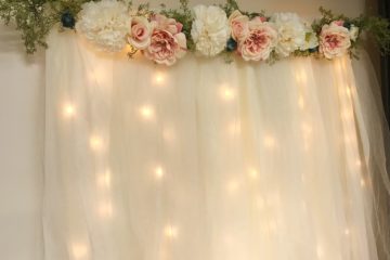 DIY Lit Tulle Backdrop | Bridal | Wedding | Bridal Shower | Wedding Shower | Photography Backdrop | Floral Decor | Backdrop | Background | Bride | Bride to Be | Wedding Shower Ideas | Shower on a Budget | Baby Shower | Simple Decorating Ideas | Easy Decor | Quick tutorial on Six Clever Sisters!