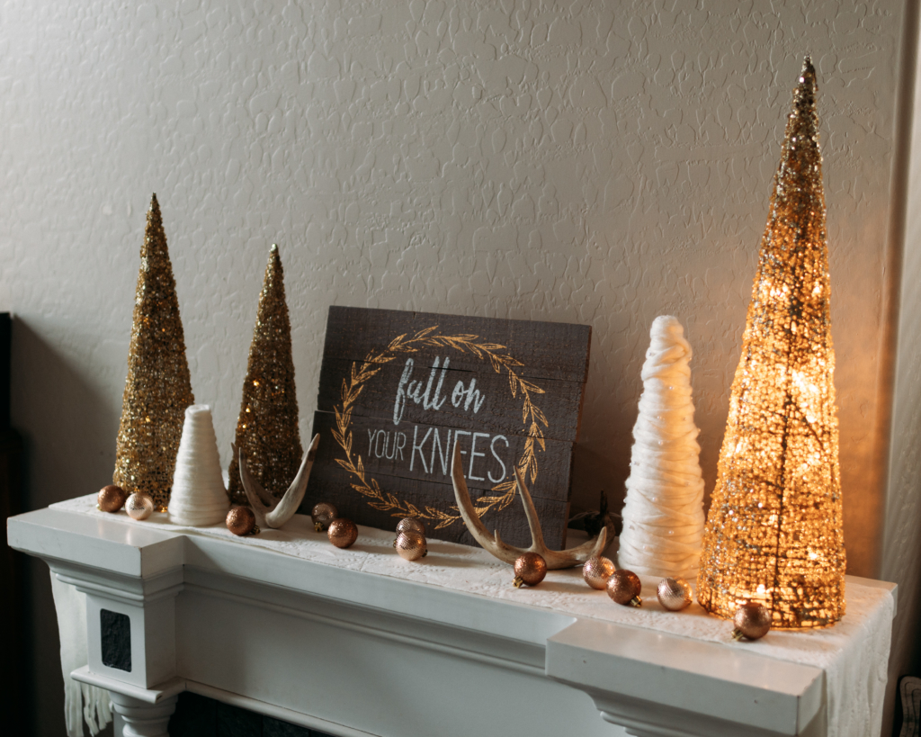 Holiday Decor | Christmas Mantle | Mantlescape | Winter Mantle | Elegant Mantlescape | Gold and White Mantle Decor | Gorgeous DIY mantle scape for winter with gold and white trees. Find the tutorial for the yarn-wrapped trees at SixCleverSisters.com.