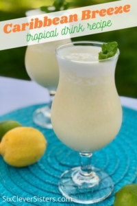 Tropical Drink | Summer Drink Recipe | Coconut Smoothie | Pineapple Drink | Fruity Drink | Drink Recipe | Easy Punch Recipe | Caribbean Breeze Drink | If you love tropical flavors and creamy sweet drinks, this Caribbean Breeze Drink is the recipe for you! Find it at SixCleverSisters.com.